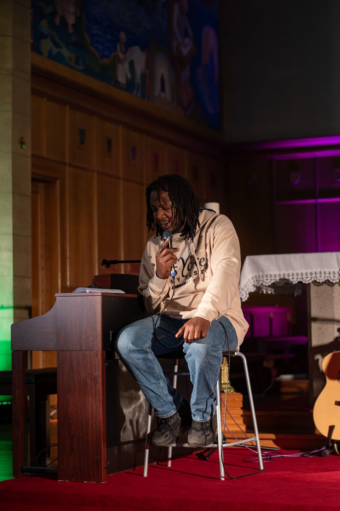 Chukwuemeka performing on stage with piano